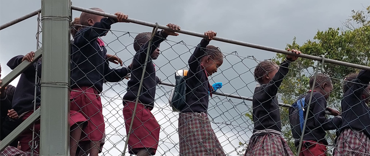 Children walking on “Reagan’s Crossing” footbridge over Sand River, Kenya.