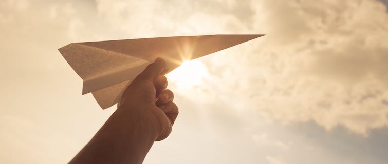 Person prepares to throw a paper airplane