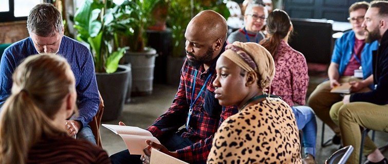 Colleagues discussing during conference workshop