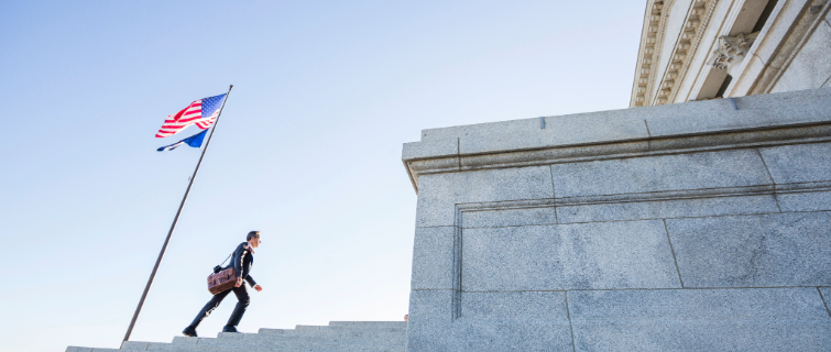 Businessman walking on courthouse steps