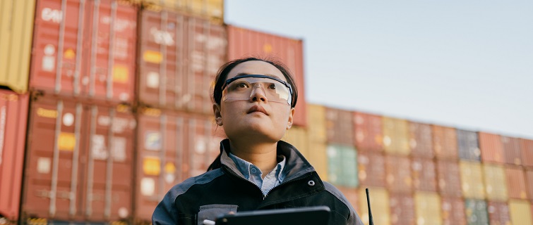 Woman surveying shipping containers