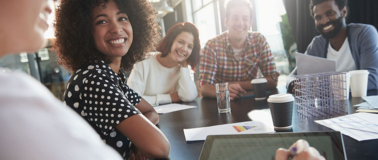 Group of educators smiling at a table.