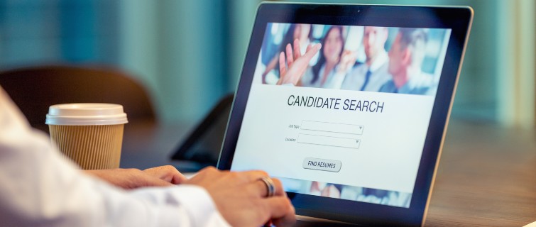 Businessman looking at recruitment website on a laptop computer.