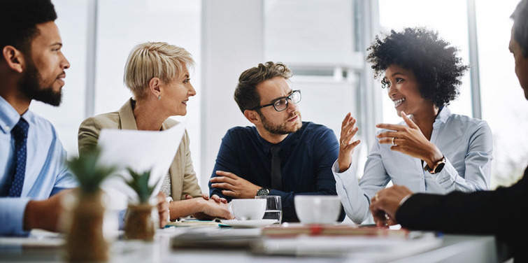 Shot of a group of businesspeople sitting together in a meeting