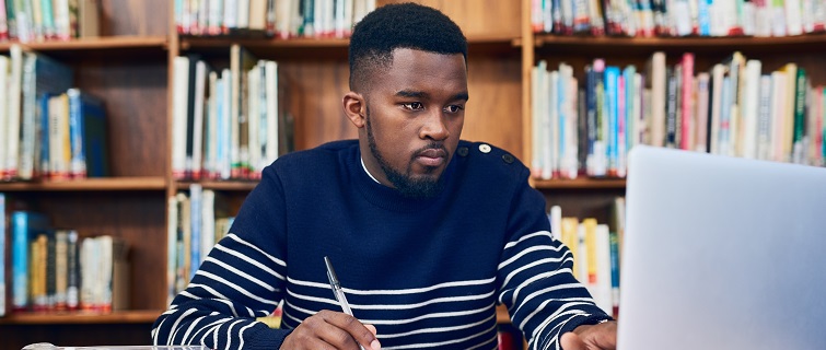 A man doing research on a laptop