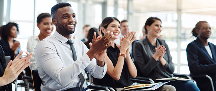 Group of business people clapping.