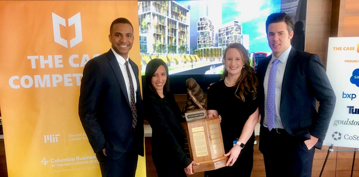Real Estate students pose with trophy after winning CASE competition