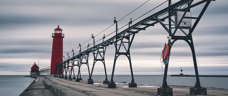 Electricity poles and lighthouse on pier