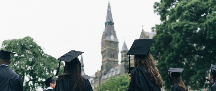 Georgetown students in caps and gowns at graduation.