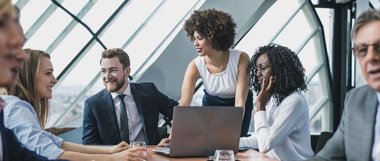 People standing around a conference table