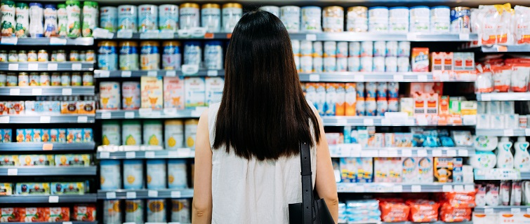 Rear view of woman looking at grocery store shelves
