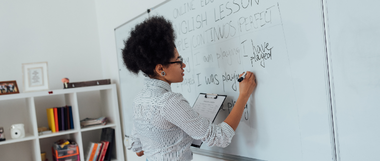 Teacher writing on a whiteboard.