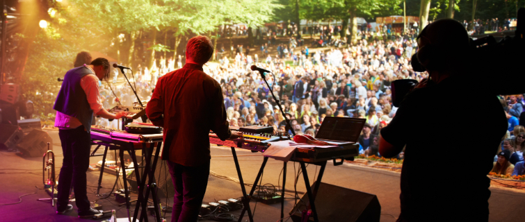 Rearview shot of a band on stage at an outdoor music festival