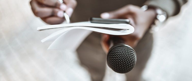 Man holding pen and microphone for interview