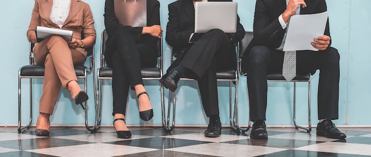 four people sitting in a waiting room