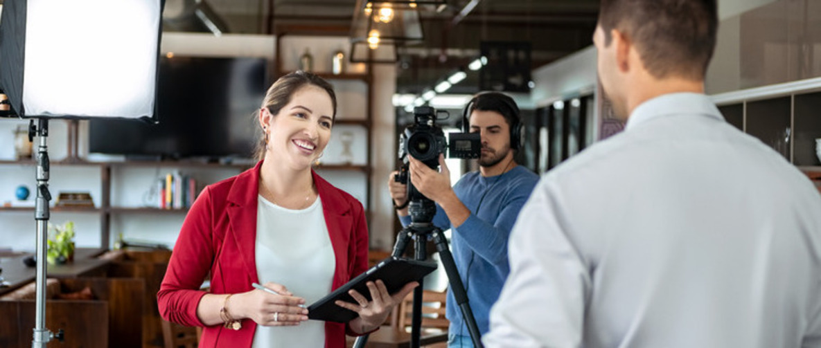 Man filming business people In office