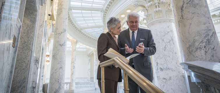 two legislators review documents in state house