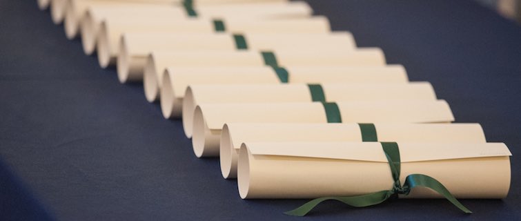 certificates lined up on a ceremonial table