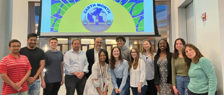 GradGov students standing in front of an Earth Month logo.