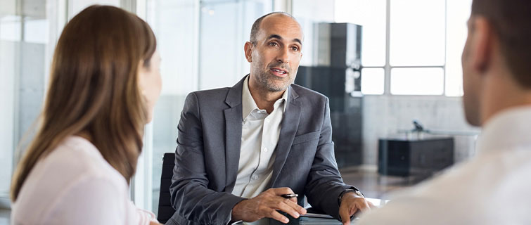 Man talking to two people