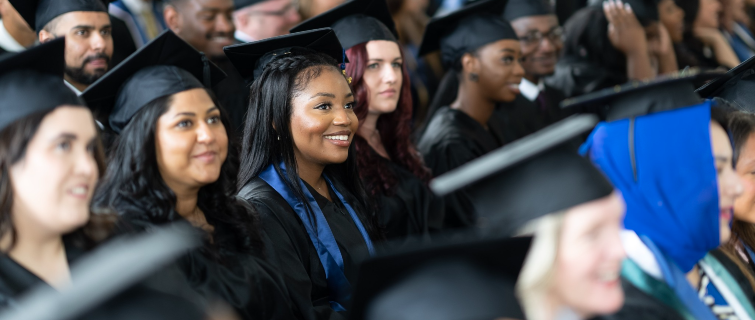 Georgetown students in caps and gowns at graduation.