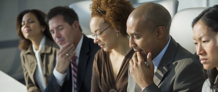 group of executives reviewing written materials