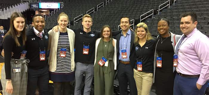 Nine of the Sports Industry Management students on the court at the Capital