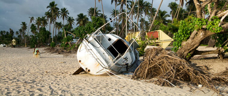 Boat damaged by hurricane aground on a beach