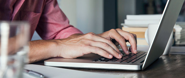 Person typing at computer