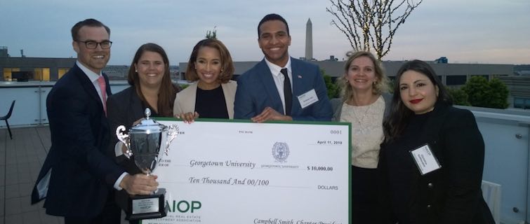 Winning Georgetown team poses with trophy and giant check