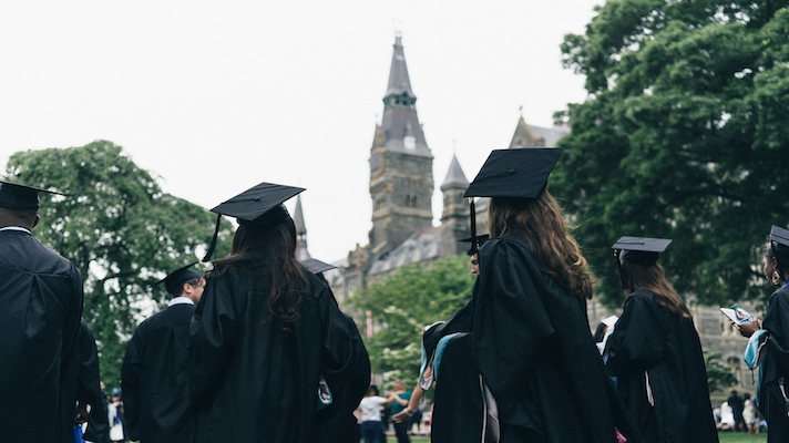 Georgetown students in caps and gowns at graduation.