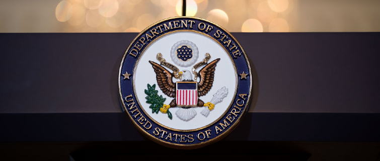 A view of the U.S. State Department seal on a podium.