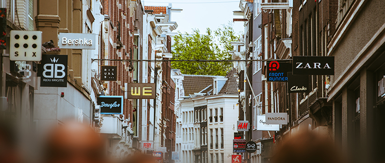 Looking down a street with chain retail stores on each side