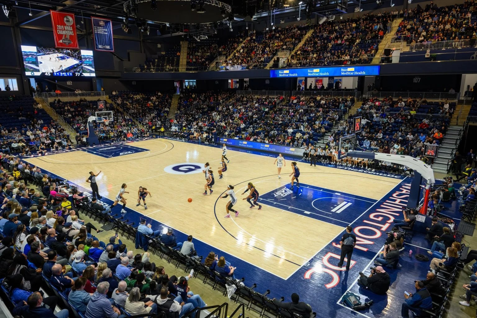 Wide, aerial shot of a women's basketball game.
