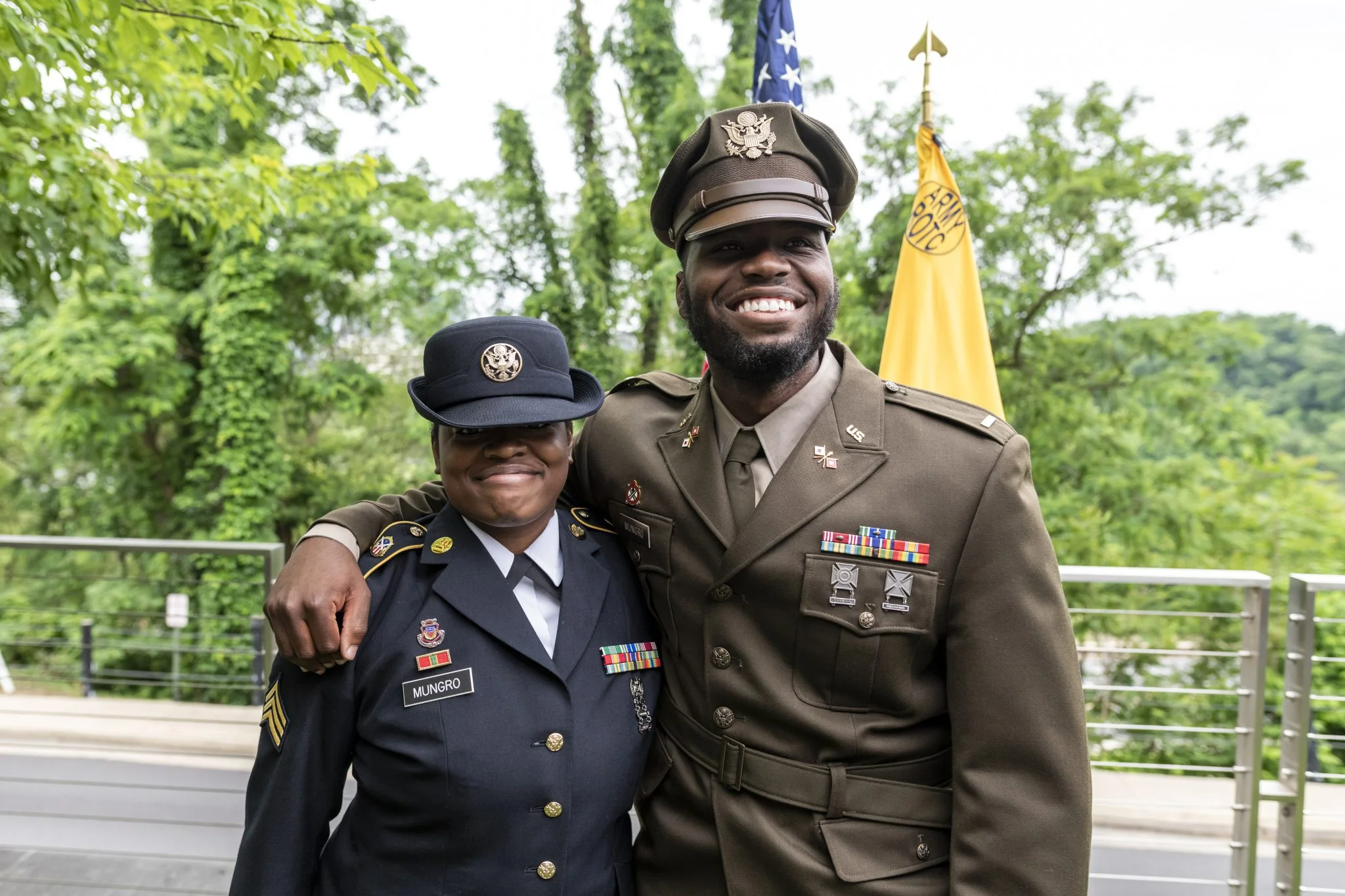 Lester Mungro gives his first salute as an officer and is pinned by his wife, Sgt. Amani Mungro.