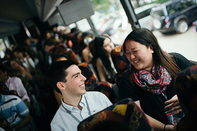 Two students chatting during bus ride